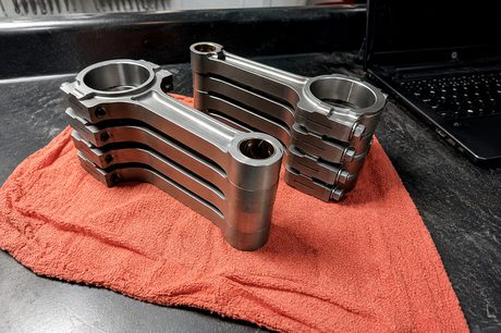 Connecting rods cleaned and laid out on the bench at DAVID's Auto Care