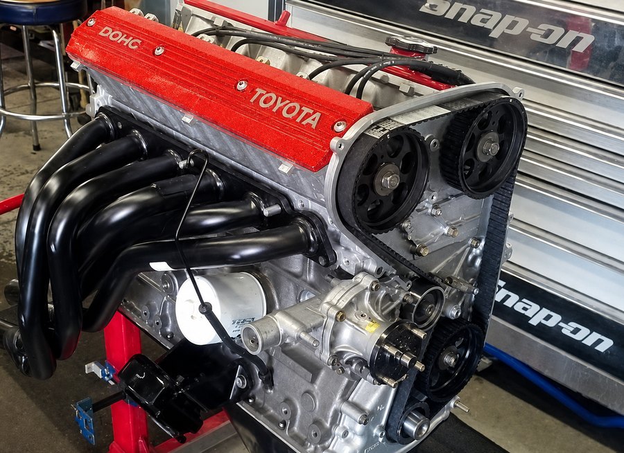 A rebuilt Toyota twin cam engine on the stand at DAVID's Auto Care in Sioux Falls