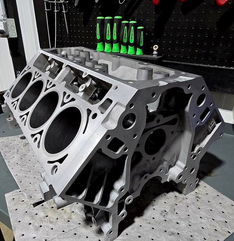 A bare V8 engine block on the bench at DAVID's Auto Care